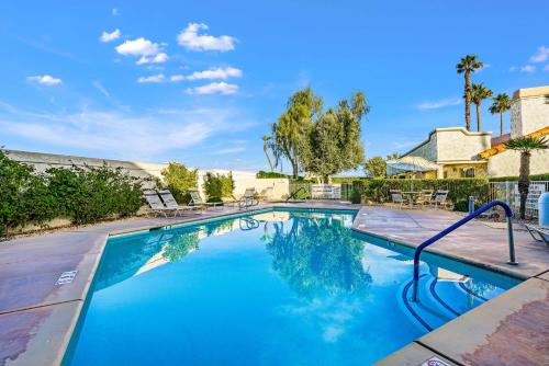 a large swimming pool with blue water at Idyll in the Desert - Immaculate Palm Desert Getaway in Palm Desert