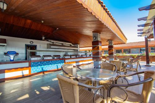 a patio with a table and chairs and a bar at Kustur Club Holiday Village - All Inclusive in Kusadası