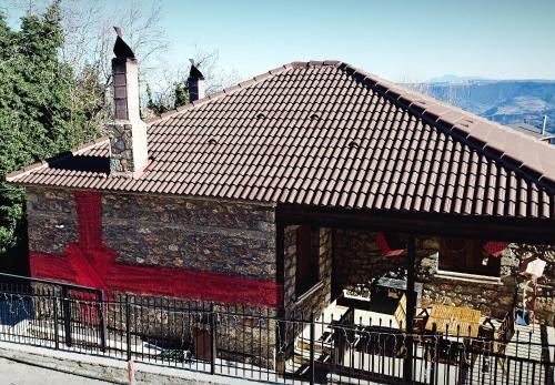 a brick building with a red scarf on it at Petradi Guesthouse in Synikia Mesi Trikalon