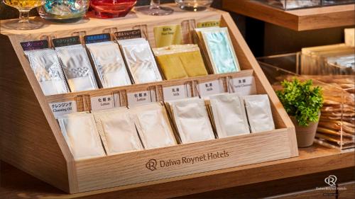 a wooden box filled with different types of cheese at Daiwa Roynet Hotel Shimbashi in Tokyo