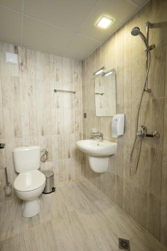 a bathroom with a toilet and a sink at Arima city in Shumen
