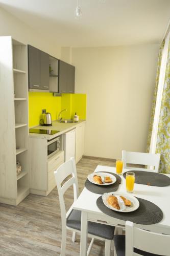 a kitchen with a table with two plates of food on it at Arima city in Shumen