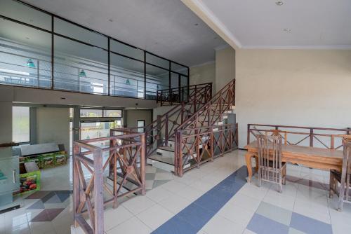 a room with a staircase and a wooden bench at RedDoorz Syariah at Jalan Sunan Giri Tuban in Tuban