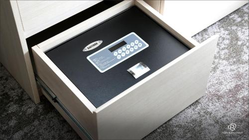 a drawer with a box with a remote control in it at Daiwa Roynet Hotel Shimbashi in Tokyo