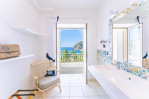 a bathroom with a view of the ocean at Hotel Ferdinando Beach & Thermal Spa in Ischia