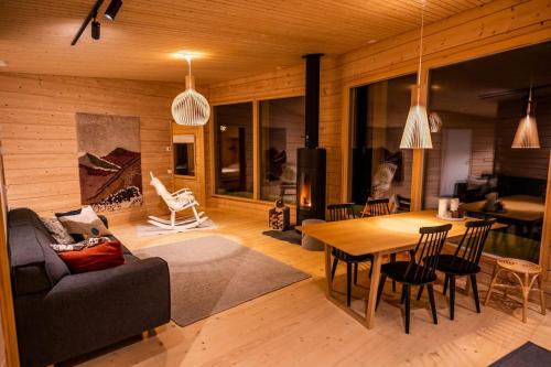 a living room with a couch and a table at Uusi hirsimökki 7 henkilölle in Inari