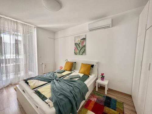 a white bedroom with a bed and a window at Panorama Apartment #W6 #Terrace #FreeParking in Budapest