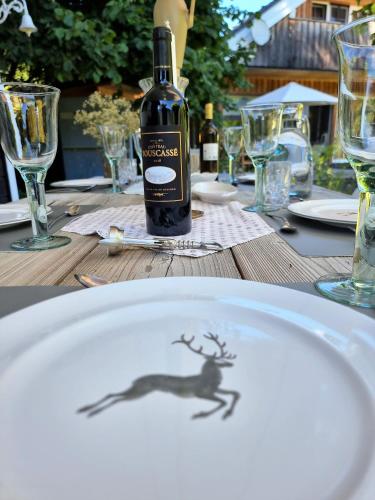 a bottle of wine sitting on top of a table at Countryhouse Lake Attersee - Traumhaft schöne Lage - Bezauberndes Hideaway in Unterach am Attersee
