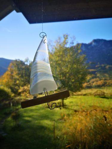 a toy boat is hanging from a window at Countryhouse Lake Attersee - Traumhaft schöne Lage - Bezauberndes Hideaway in Unterach am Attersee