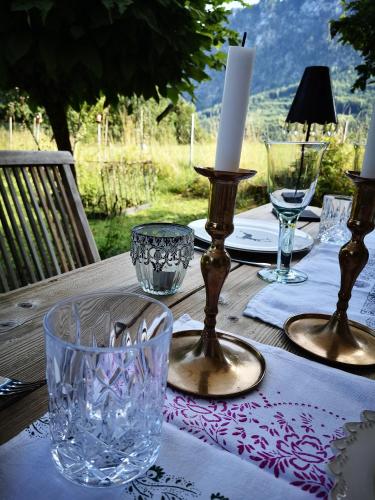 a table with a candle and glasses on top of it at Countryhouse Lake Attersee - Traumhaft schöne Lage - Bezauberndes Hideaway in Unterach am Attersee