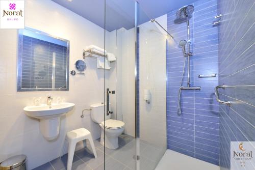 a bathroom with a shower and a toilet and a sink at Nuevo Norat Sanxenxo in Sanxenxo