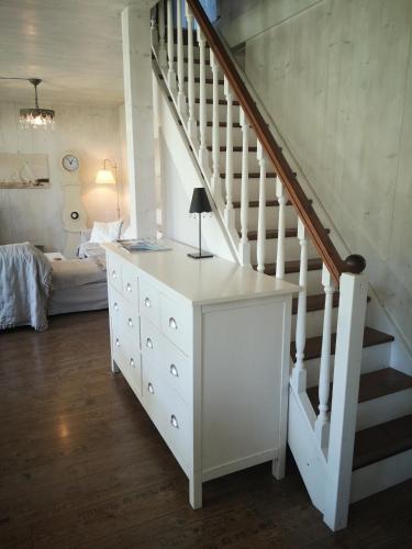 a room with a white dresser and a staircase at Countryhouse Lake Attersee - Traumhaft schöne Lage - Bezauberndes Hideaway in Unterach am Attersee