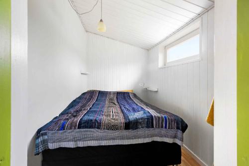 Una cama o camas en una habitación de Cozy 'Witch's House' With Fjord View