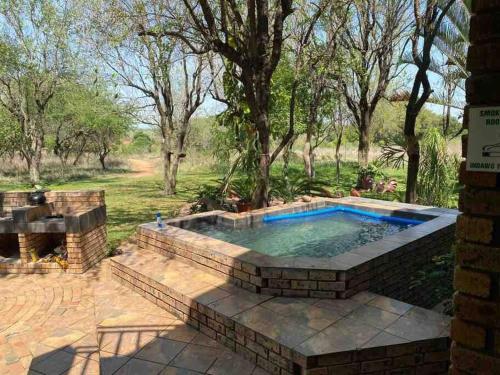 a swimming pool in the middle of a yard at Stadigies Self-Catering Accommodation in Marloth Park