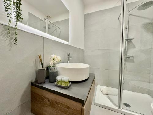 a white bathroom with a sink and a shower at Diasof Apartments in Rome