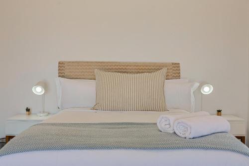 a white bed with two towels on top of it at 38 on Westcliff in Hermanus