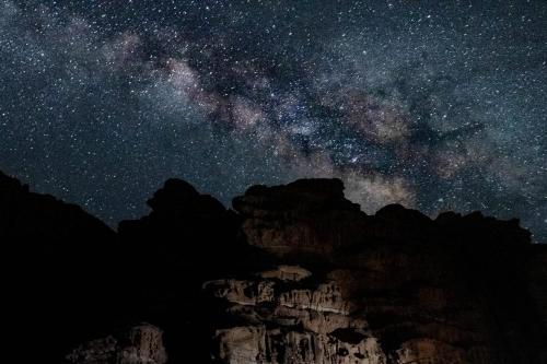 a starry night with the milky way over a mountain at Wadi Rum Bedouin Heart in Wadi Rum