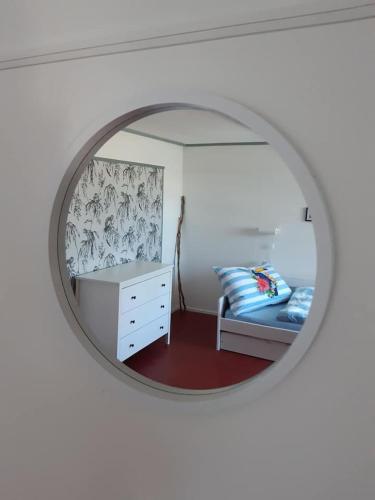 a bedroom with a bed and a mirror at Böglihuus in Bellelay