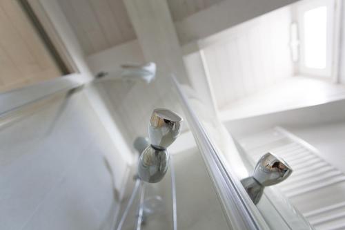 a shower with two faucets in a bathroom at Residenza dei Suoni in Matera