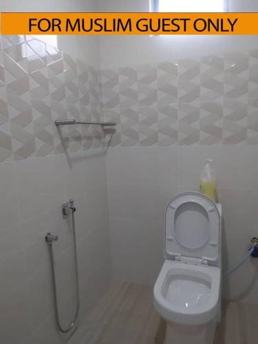 uma casa de banho com um WC e um chuveiro em Yasmeen Studio Roomstay Kijal - Room 1 - FOR TWO PERSON ISLAM GUEST ONLY em Kijal