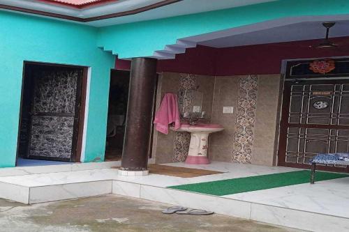 a house with a bathroom with a sink and a door at POP Pinki Homestay in Arli