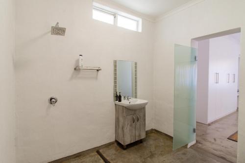 a bathroom with a sink and a mirror at 38 on Westcliff in Hermanus