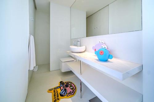 a white bathroom with a sink and a mirror at Villa Iris Javea by Rock Rentals in Balcon del Mar