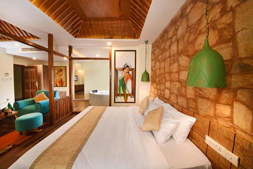 um quarto com uma cama e uma parede de pedra em Woodapple Hotel and Spa em Kathmandu