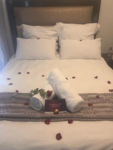 Una cama con rosas y un par de calcetines. en Kay’s place, en Pretoria