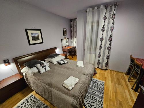 a bedroom with a bed with two towels on it at Apartament Bystra Woda 28 z garażem in Zakopane