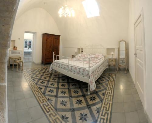a bedroom with a bed and a tub in it at Masseria Luco in Martina Franca
