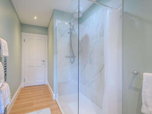 a bathroom with a shower with a glass door at 1 Bed in Lockerbie 86068 in Lockerbie