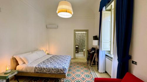 a bedroom with a bed and a living room at Civico 43 in Messina