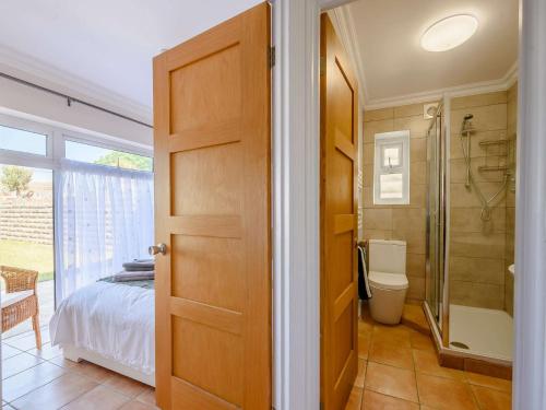 a bathroom with a bed and a shower and a toilet at 4 Bed in Ogmore-By-Sea 87141 in Saint Brides Major