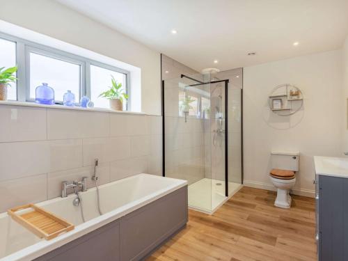 a bathroom with a bath tub and a toilet at 3 Bed in Shaftesbury 87724 in Sedghill