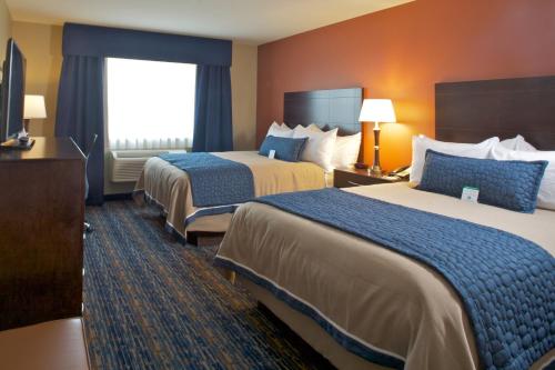 Кровать или кровати в номере Grandstay Hotel & Suites Mount Horeb - Madison