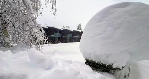 a pile of snow in front of a building at Euphoria Club Hotel in Borovets