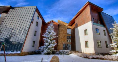 a building with a christmas tree in front of it at Euphoria Club Hotel in Borovets