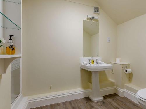a bathroom with a sink and a mirror at 2 Bed in Somerton 89115 in Somerton