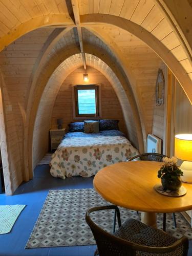 a bedroom with a bed and a table in a room at Silverspring Hideaways in Constantine