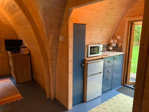 a kitchen in a tiny house with a microwave at Silverspring Hideaways in Constantine