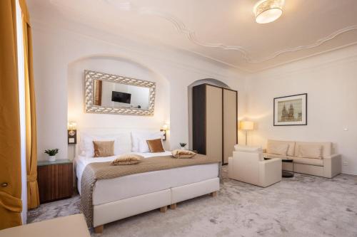 a bedroom with a large bed and a mirror at Bellevue Hotel Český Krumlov in Český Krumlov