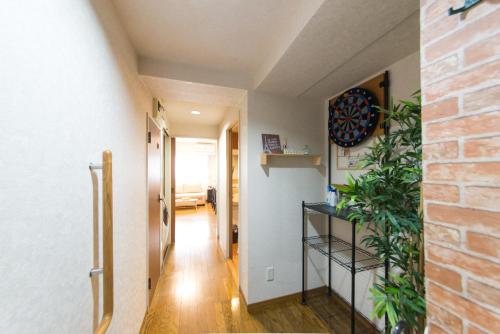 a hallway with a staircase and a brick wall at nestay apartment tokyo akihabara in Tokyo