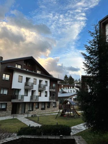 an apartment building with a playground in front of it at Lodge Euphoria Studio in Borovets