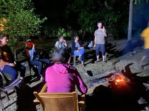 a group of people sitting around a fire at Moonshade Handapanagala in Monaragala