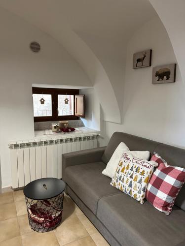 a living room with a couch and a table at Casa Rocca di Cambio in Rocca di Cambio