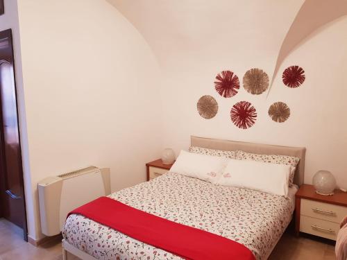 a bedroom with a bed with a red blanket at La Tana degli Orsetti in Barrea