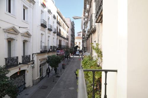 an empty street in a city with buildings at numa I Luna Apartments in Madrid