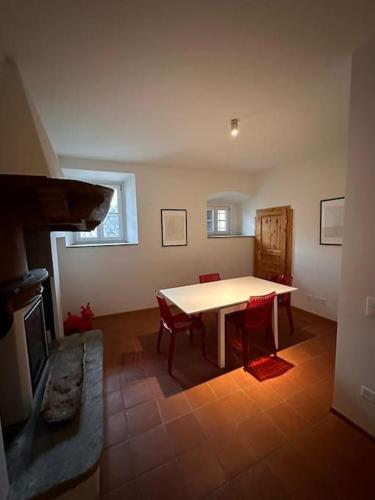 a dining room with a table and a fireplace at Rancate charme apartment in Mendrisio