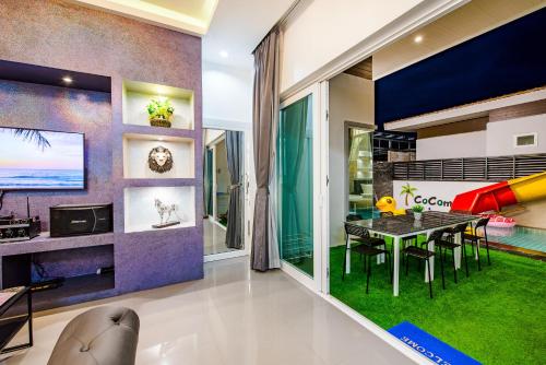 a dining room with a dining table and a playroom at Cocomelon Poolvilla1 in Hua Hin